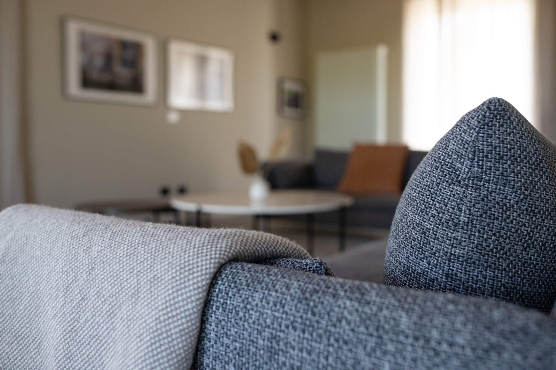 Living room sofa detail with soft neutral textiles
